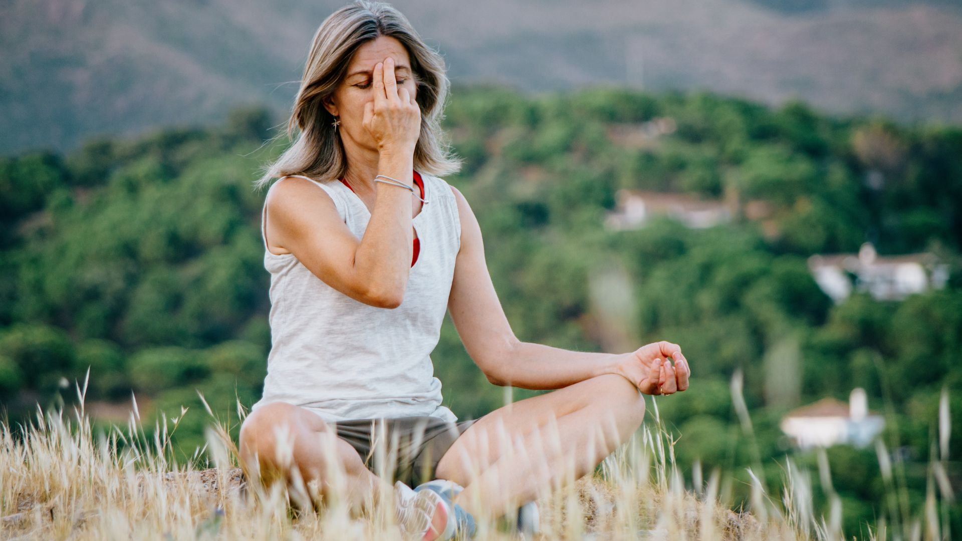 Woman sat in silence covering forehead